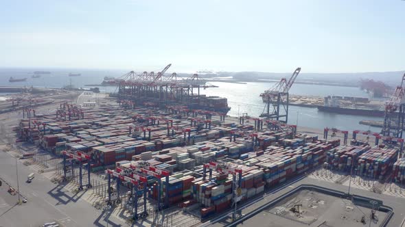 Cargo containers in busy port, aerial. Drone shot.  alt