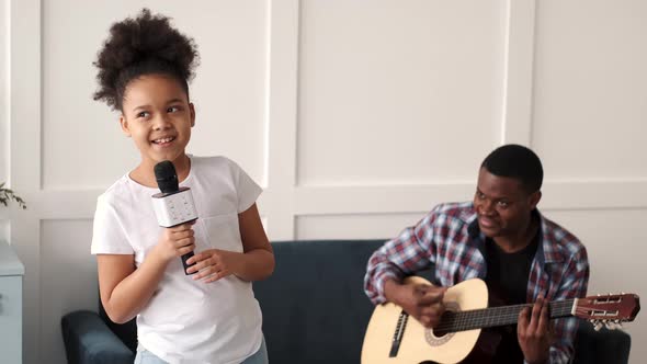 African Father Playing Guitar Daughter Singing alt