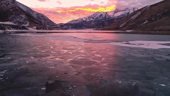 Vibrant sky glowing reflecting off ice on lake through the texture alt