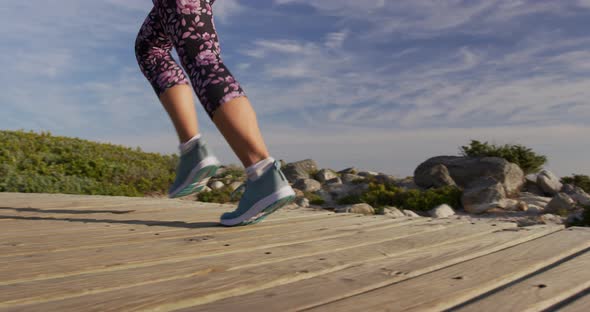 Caucasian woman enjoying free time by sea on sunny day running path alt