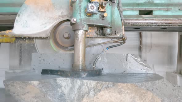 Large Industrial Stone Cutter Cuts Granite Rock Into Plates in Jets of Water Close Up