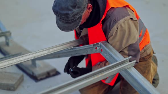 Solar power plant. Fitting solar panels to roof of building alt