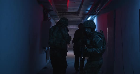 Unrecognizable Soldiers Examining Dark Corridor alt