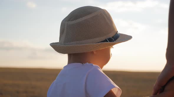 Mother and Little Son Holding Hands Into the Sunset. Child Have a Trust for Mother, Family Concept alt