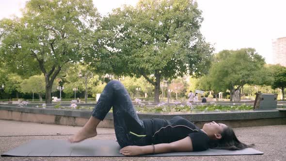 Asian woman exercise in park outdoor with new normal in COVID-19 situation alt