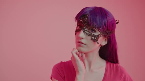 Enigmatic European Woman Wearing a Silk Mask Looks Attractively Into the Camera Medium Closeup Shot alt