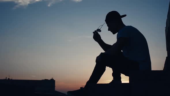 Silhouette of a Man in the City at Sunset alt