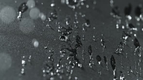 Super Slow Motion Shot of Water Droplets Splashing on Waterproof Cloth at 1000Fps alt
