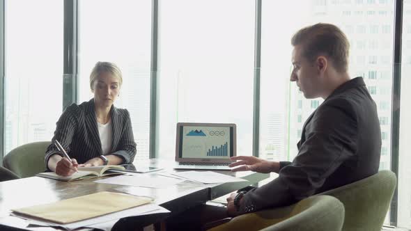 Manager meeting and discussion report statistic chart and graph on screen laptop computer. alt