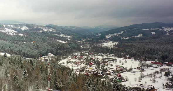 Forest Covered with Snow Aerial View. Aerial View of Village in Mountains alt