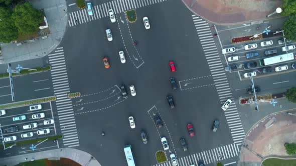 Aerial Drone Rotating Shot of Crossroad in the City Cars and Buses Driving By Avenue alt