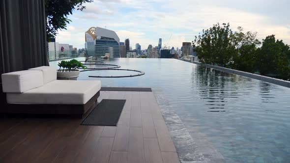 Walk Near Swimming Pool on Rooftop of Residential Skyscraper Building Cityscape alt