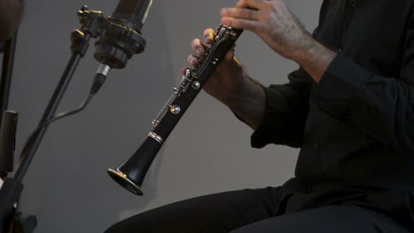 Clarinetist at a concert, theater scene, clarinet, flat plane closeup alt