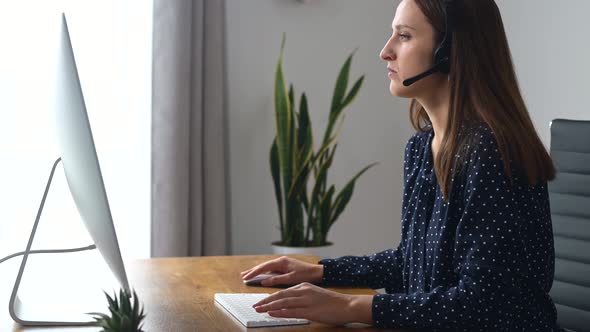 Woman is Using Headset for Online Communication alt