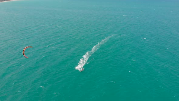 Acrobatic Jump of Professional Kite Surfer on the Sea Wave, Athlete Showing Sport Trick Jumping with alt