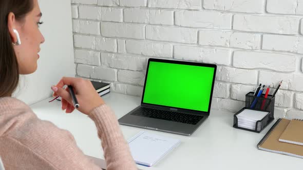 Thoughtful female study online conference webcam video call green screen laptop alt