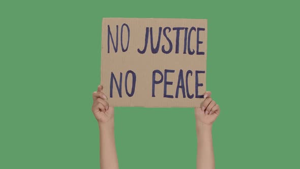 Female Hands Hold a Poster From a Cardboard Box with the Words NO JUSTICE NO PEACE. Protest Against alt