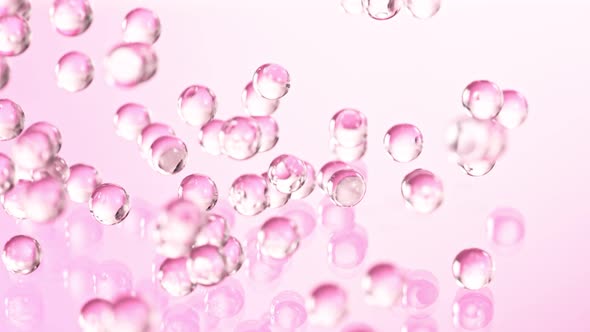 Super Slow Motion Shot of Pink Hydrogel Balls Bouncing on Glass at 1000Fps alt