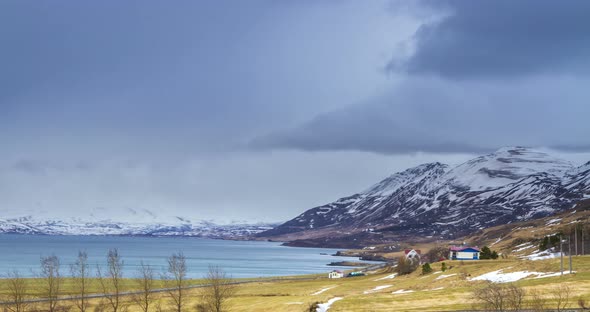 Cloud rolling time lapse over snow mountain fjords in Akureyri, Iceland.