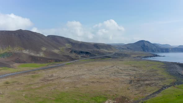 Aerial View of Coastline of Iceland with Volcanic Black Sand Beach and Ring Road Highway alt