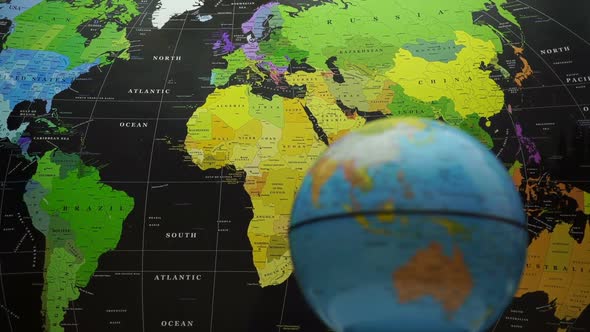 Rotating Globe On World Map Background.