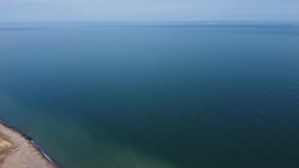 Aerial view drone flies near the sea. Wide view of the water. Beautiful blue sea.
