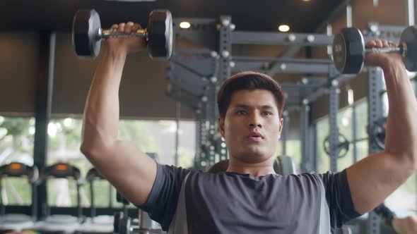 Young athlete Asian guy in sportswear exercise running on treadmill fat burning workout.