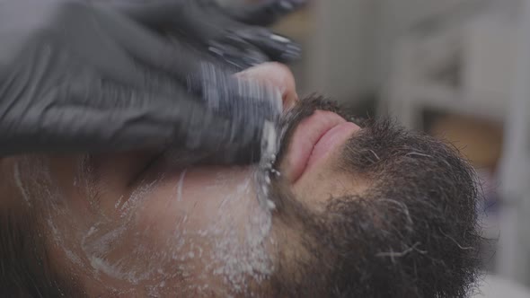 Closeup of Young Man Face with Cleansing White Mask on Face alt