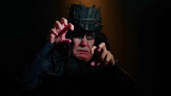 Frightening Senior Man with Halloween Witcher Makeup Looking at Camera Trying to Scare Show Tongue alt