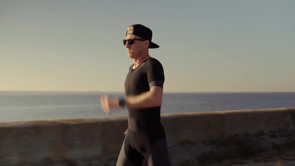 Running Triathlete Man. Runner Man Fit Athlete Legs Jogging On Trail Ready To Triathlon. Workout alt