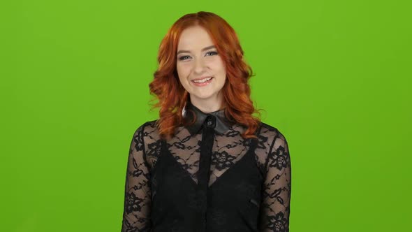 Girl Is a Passive, She Shows Her Finger Up with Both Hands, Smiles. Green Screen. Close Up alt