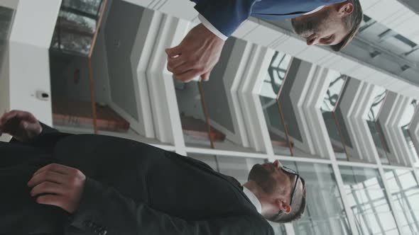 Vertical Shot of Businessman Shaking Hand to his Lawyer alt