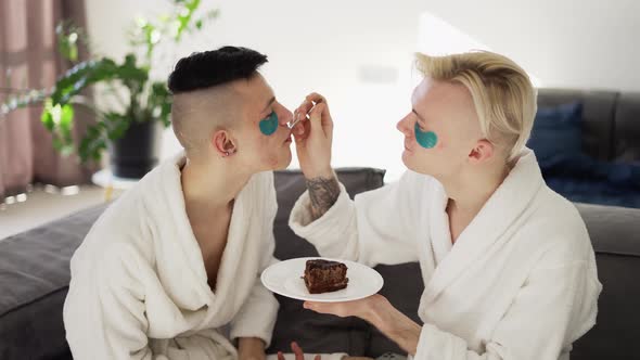 Domestic Homosexual Couple Feeding Each Other with Cake alt