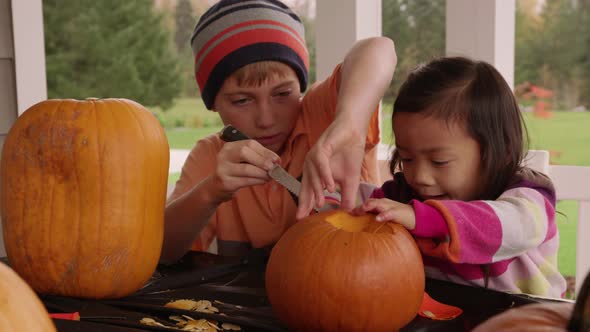 Kids carving pumpkins for Halloween