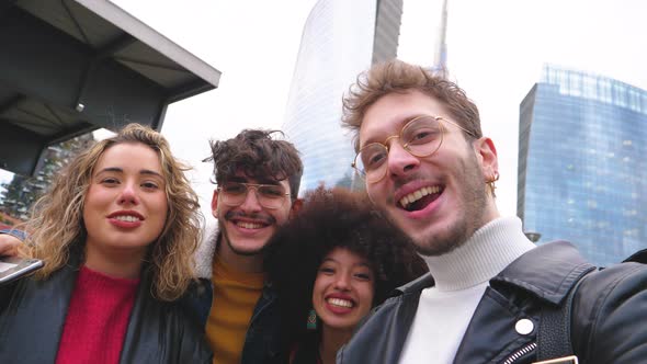 Group of four people diverse multiethnic tourist having fun taking selfie alt