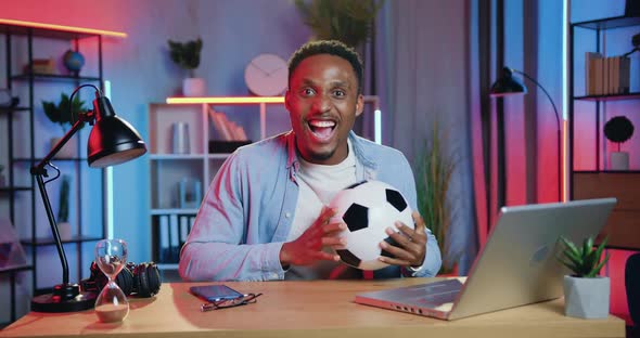 Black-Skinned Man Throwing Ball Over His Head when His Favourite Football team Scored Goal alt
