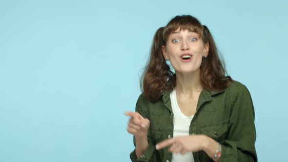 Slow Motion of Amazed Brunette Woman Pointing Fingers Left at Copy Space Showing Logo and Looking