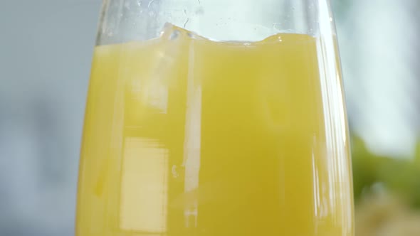 Orange Juice With Ice Cubes Rotating In Glass