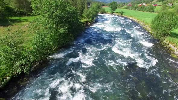 Flying above fast river in Norway alt