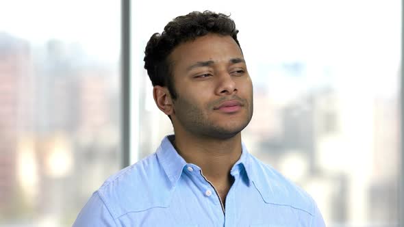 Close Up of Pensive Businessman on Blurred Background. alt