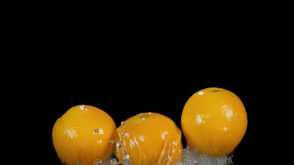 Three Ripe Juicy Oranges are Bouncing From the Water with the Beautiful Splashes alt