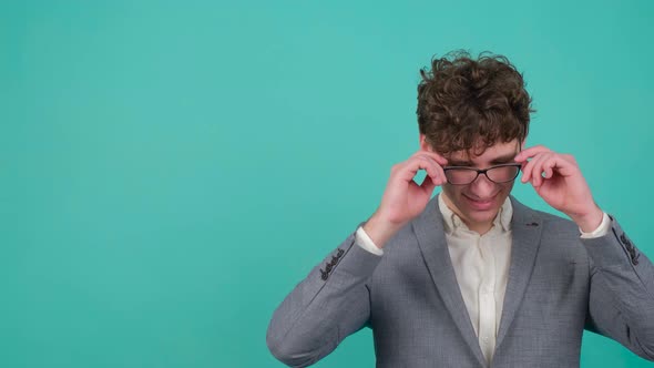 Man Takes Off His Glasses and Makes the Stop Gesture As a Sign to Stop Wearing It alt