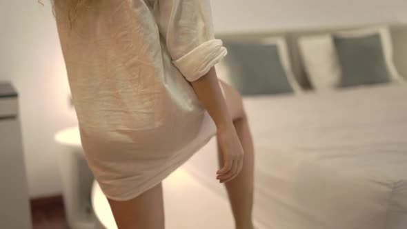 Sexy Young Woman in Underwear Under White Shirt Falls on Bed alt