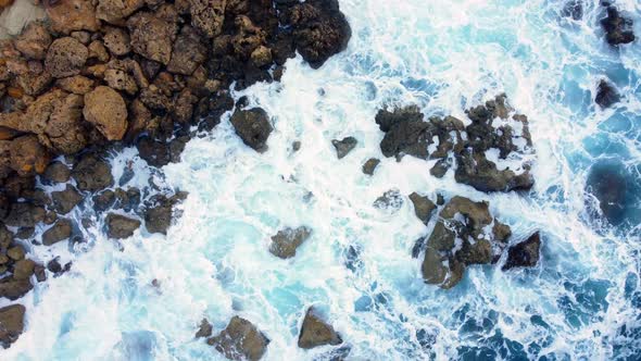Ocean Coastline Cliffside with Blue Pure Water Sea Waves Washes the Rocky Shore Above Aerial Shot alt