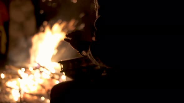 Silhouette of Drummer Playing with Hands on Percussion Drum by Campfire alt