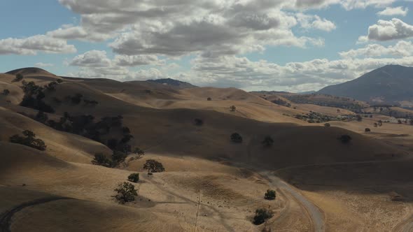 Aerial shot of California countryside with hills with perfect blue skies and clouds, Concord CA alt