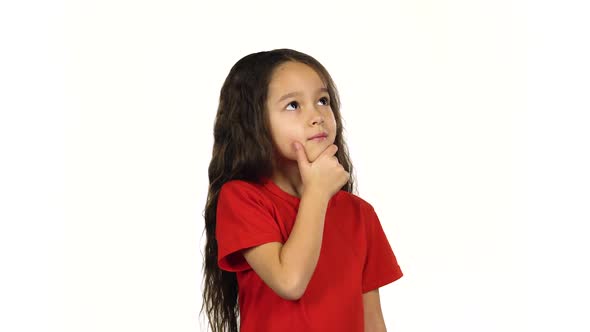 Portrait of Happy Little Girl Posing and Thinking About Something on White Background alt
