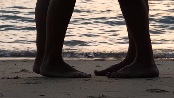 Silhouette of Male and Female Legs at Sea Beach
