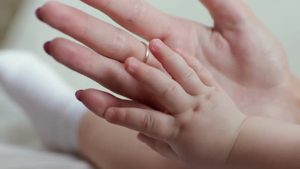 Hand of a newborn. Baby hand in mother hand