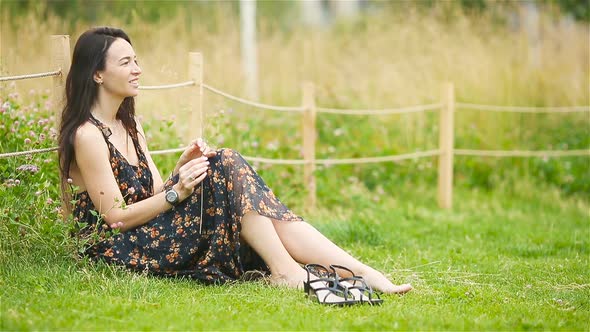 Cute Woman Relaxing in the Park Outdoors